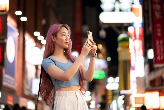 Urban portrait of young woman with long pink hair