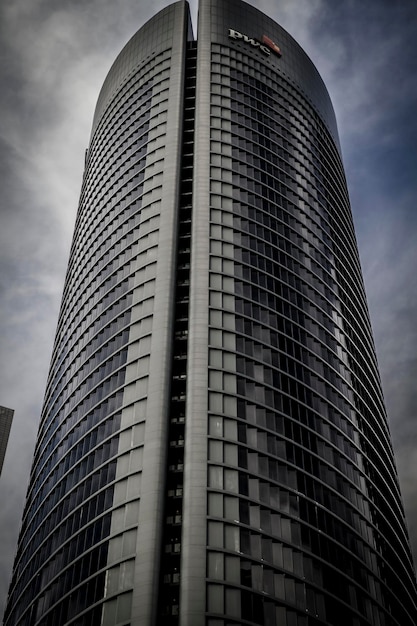 urban, skyscraper with glass facade and clouds reflected in windows