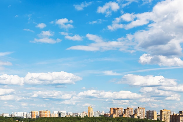 Urban street under blue sky with fluffy clouds