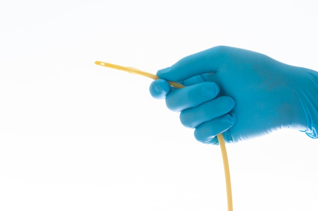 Urethral catheter hold on blue glove hand