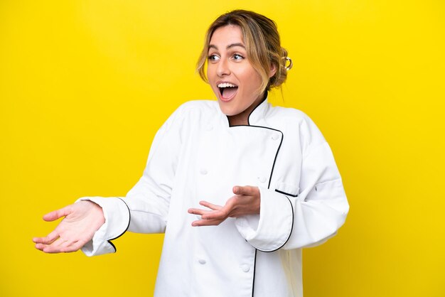 Uruguayan chef woman isolated on yellow background with surprise facial expression