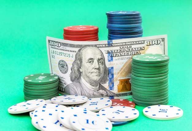 US dollar bill with poker chips on green background