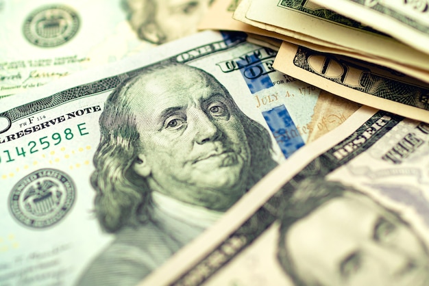 US Dollar bills on a wooden table in closeup photography