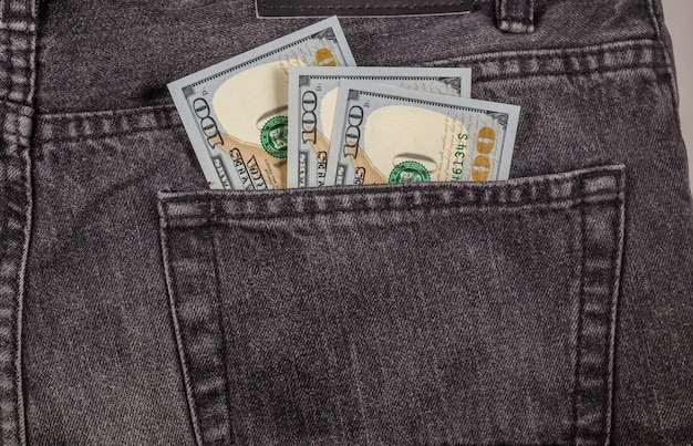 US dollars in the back pocket of jeans.