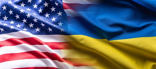 US flag together with Ukrainian flag in a single picture flags blending one into the other