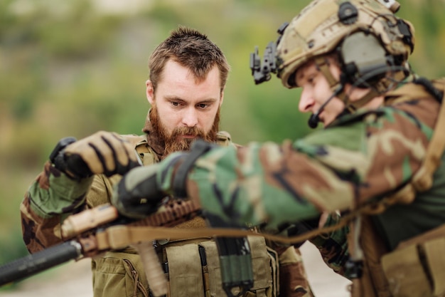 Us Instructor with soldier aiming rifle at firing range