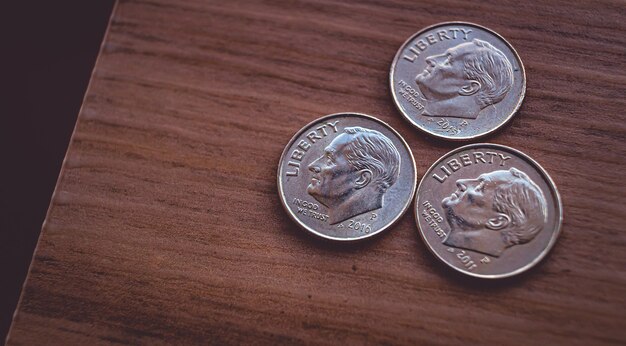 us one dime coin on a wooden object with top view