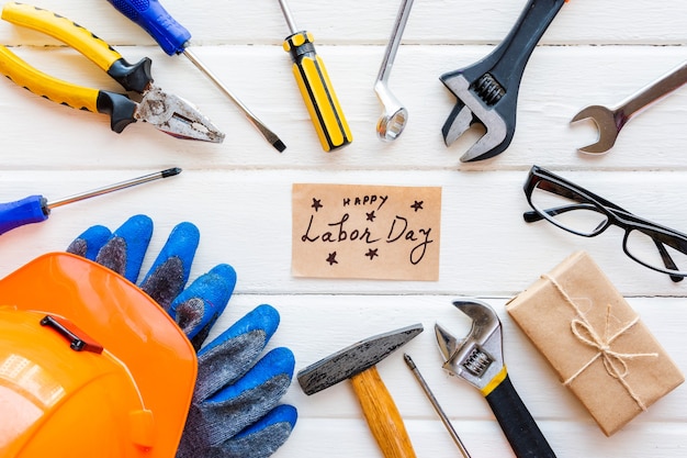 USA Labor day concept. Different kinds on wrenches, handy tools, tag on white rustic background.