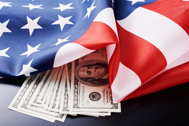 USA national flag and currency usd money banknotes on a dark . Business and finance 