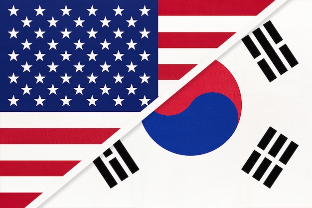 USA vs South Korea national flag from textile. Relationship between two american and asian countries.