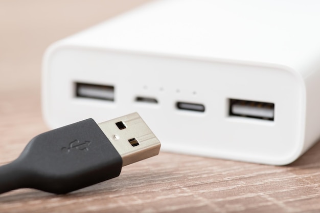 Usb cable close up on the desk white powerbank on the background