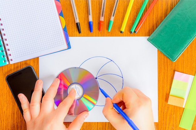 Use a CD to draw a circle and other circular shapes instead of a compass. Original use of the CD. Creative CD application.