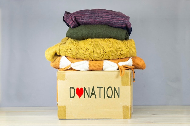 used clothes in carton box for donation collection and support of war victims helping people char