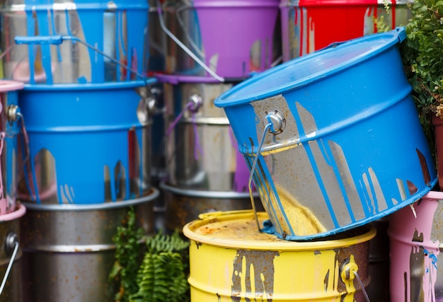 used paint cans stacked