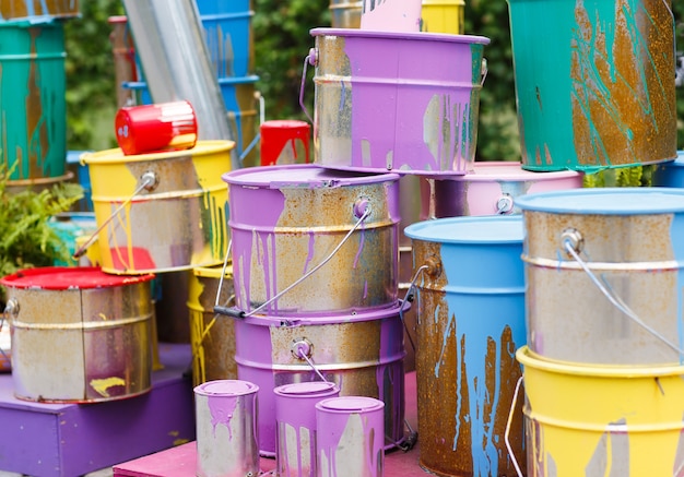 used paint cans stacked