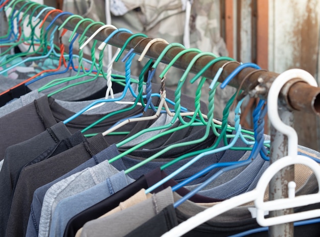 Used shirts are placed in a hanger to dry in the sunlight.