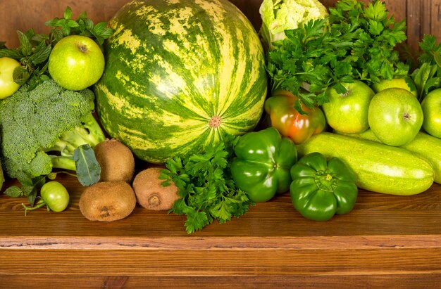 Useful green vegetables on a wooden surface