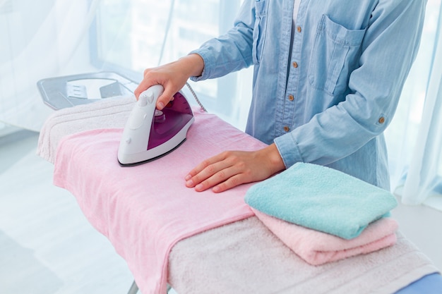 Using iron for ironing of linen and clothes after washing