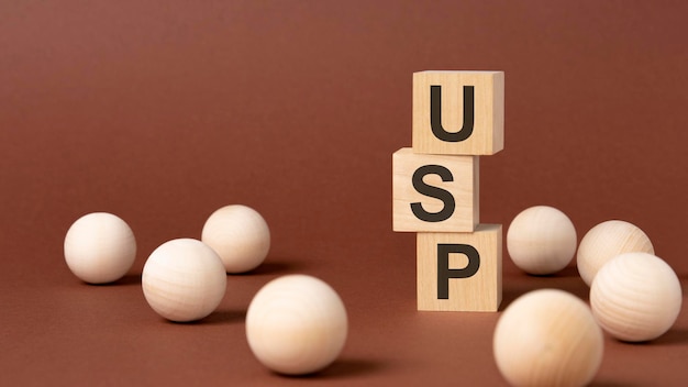 USP word is written on wooden cubes on a brown background closeup of wooden elements