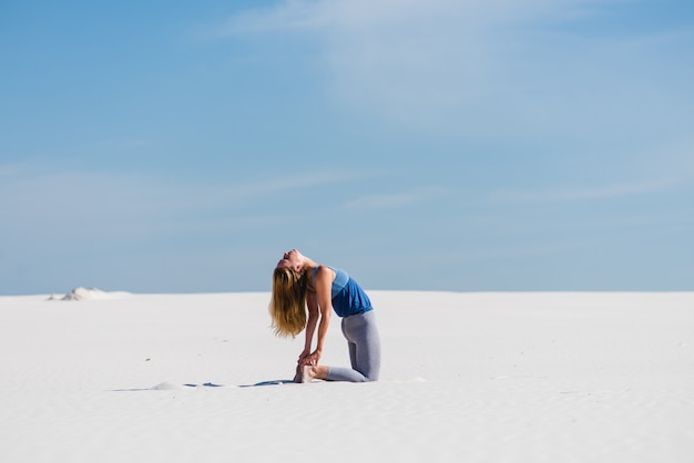 Ustrasana camel yoga pose in the desert