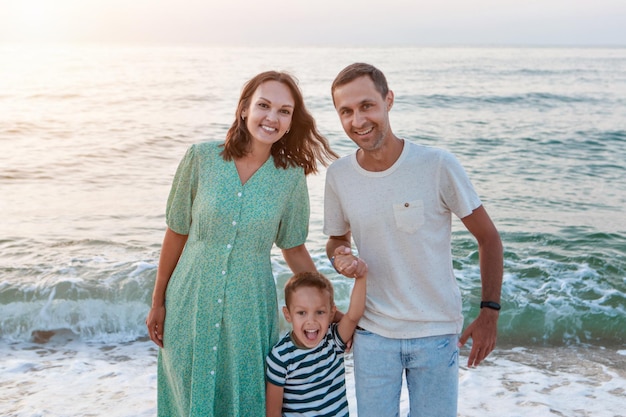 Vacation at sea. A family walks along the beach. family holding hands