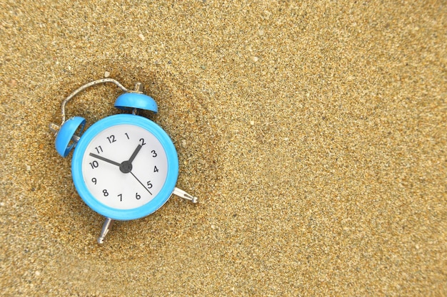 Vacation time Alarm clock on the sand