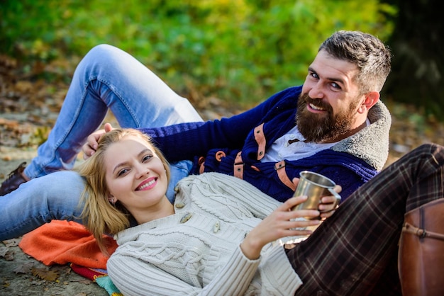 Vacation weekend picnic camping and hiking Tourism concept Picnic time Happy loving couple relaxing in park together Romantic picnic forest Couple in love tourists relaxing on picnic blanket