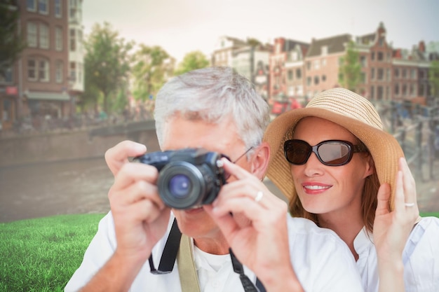 Vacationing couple taking photo against sunny day in amsterdam