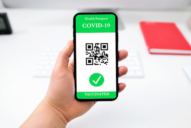 Vaccinated person using digital health passport app in mobile phone