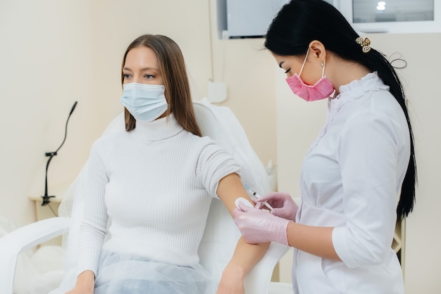 Vaccination of a girl against flu and coronavirus infection during a worldwide pandemic. The formation of the immune system and antibodies.