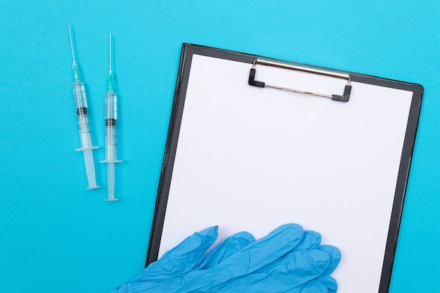 Vaccination or revaccination concept  two medical syringe on blue table