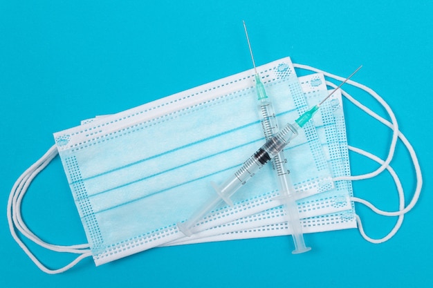 Vaccination or revaccination concept  two medical syringe on blue table