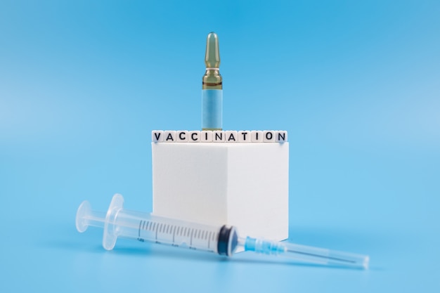 Vaccination. Vaccine concept with syringe and medical ampoules.