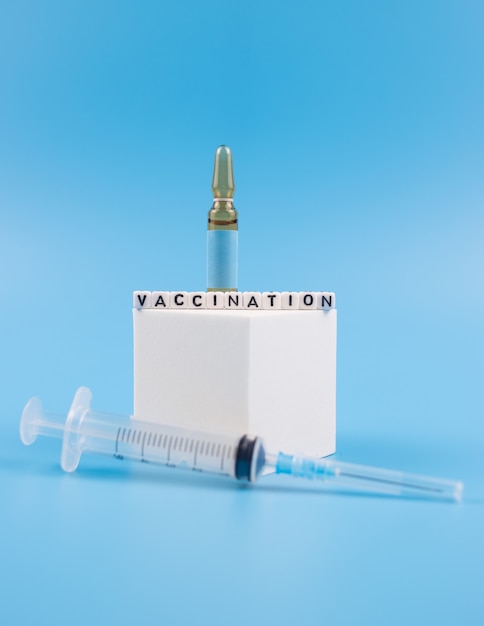 Vaccination. Vaccine concept with syringe and medical ampoules.