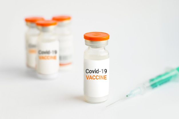 Vaccine against covid 19. Several jars with coronavirus vaccine and a syringe