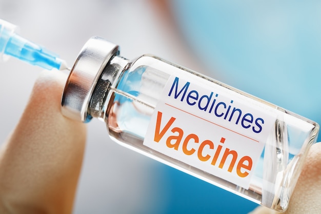 Vaccine ampoule in the hands of a physician researcher