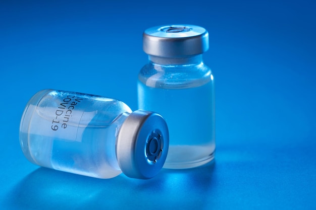 Vaccine bottle on the blue background