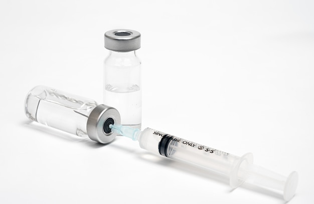 Vaccine concept with syringe and vial on white