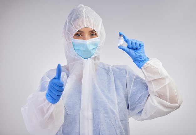 The vaccine has been approved Shot of a female nurse holding a vaccination vial against a studio background