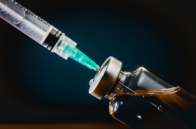 vaccine and syringe medical in a wooden table