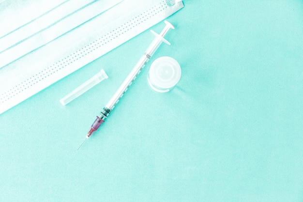 Vaccine on a vial bottle and injection Syringe on a white table