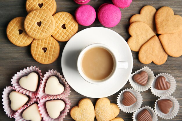 Valentine concept Composition of cup cookies and candies on blue background