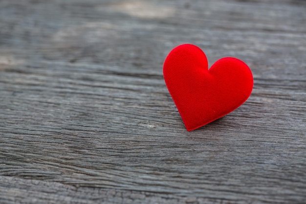 valentine day background, red love heart on grunge wooden table close up