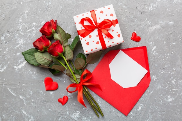 Valentine day composition with Envelope rose flower and Red heart on table Top view flat lay Holiday concept