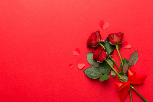 Valentine day composition with rose flower and red heart on table Top view flat lay copy space Holiday concept