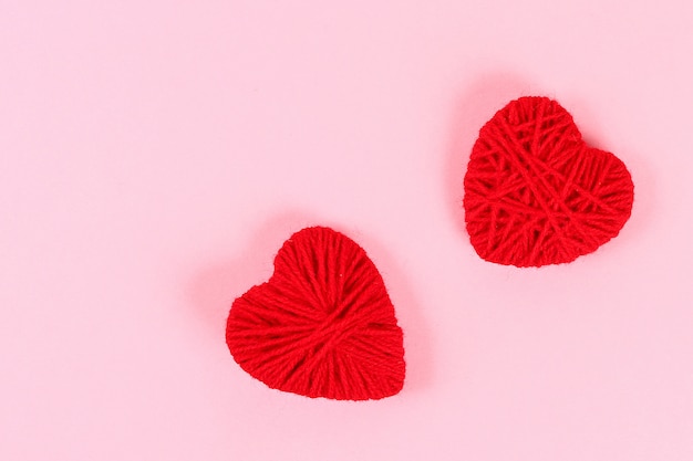 Valentine day layout. Red homemade diy hearts made of cardboard and yarn 