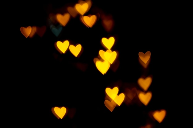 Valentine grunge heart shaped lights background. Yellow gold and blue heart-shaped on black background Colorful lighting bokeh for decoration Valentine, Love Pictures background