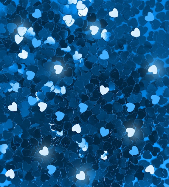 Photo valentine's day 2023 glitter background. blue hearts confetti wallpaper. greeting card or banner