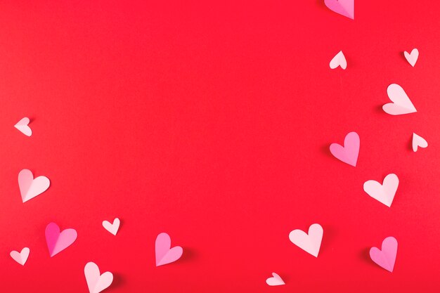 Valentine's day background with hearts on red and copy space.