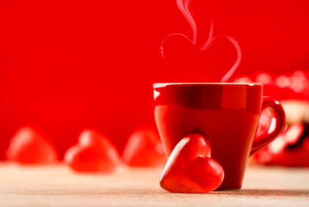 Valentine's day celebration or love concept Cups of tea or coffee with heart shape red background Copy space